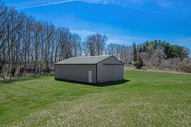 view of outdoor structure featuring a lawn