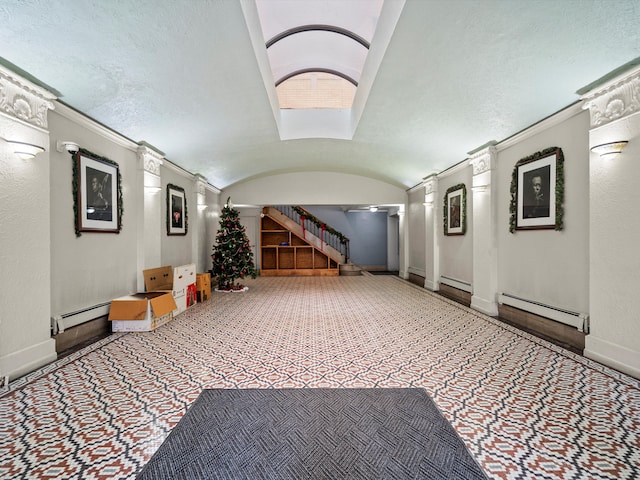 interior space featuring brick ceiling, a baseboard radiator, and lofted ceiling