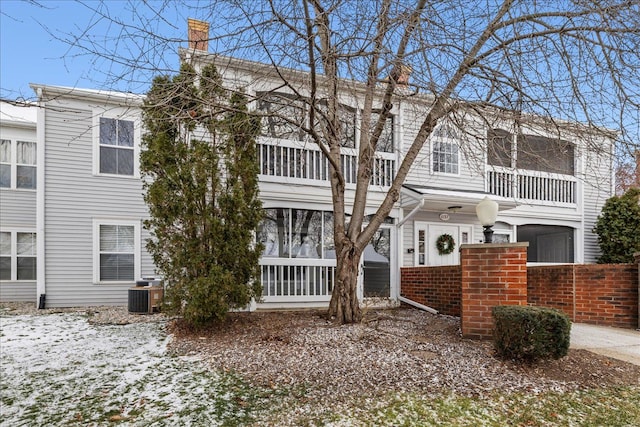 view of front of property with a balcony and central AC