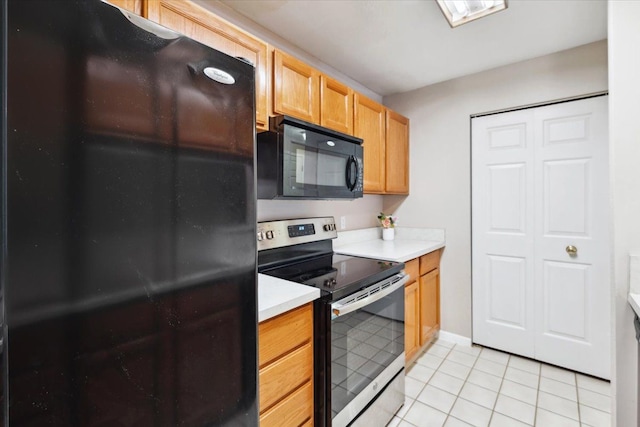 kitchen featuring black appliances and light tile patterned flooring