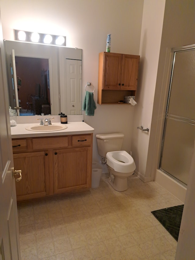 bathroom with toilet, vanity, and walk in shower