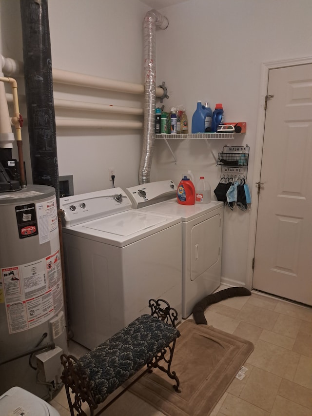 clothes washing area with washing machine and clothes dryer and water heater