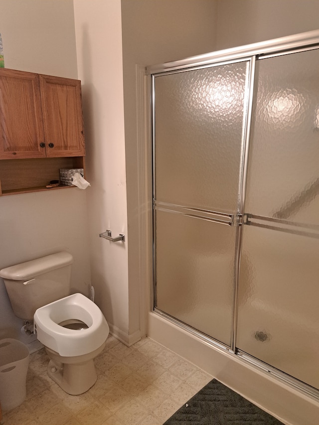 bathroom featuring toilet and walk in shower