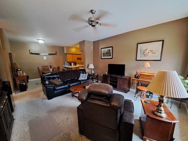 living room with ceiling fan and light colored carpet