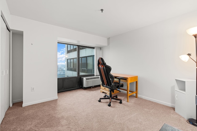 home office featuring an AC wall unit and carpet