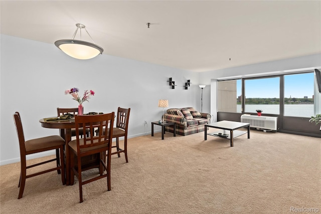 1001 W Jefferson Ave Unit 10E, Detroit, MI 48226 - dining space with light carpet, a wall mounted AC, baseboards, and a water view