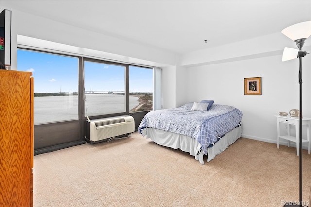 1001 W Jefferson Ave Unit 10E, Detroit, MI 48226 - bedroom with carpet floors, a water view, and a wall mounted air conditioner