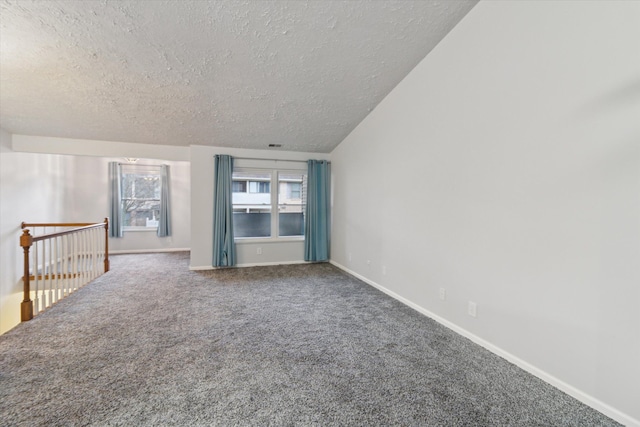 spare room with carpet floors and a textured ceiling