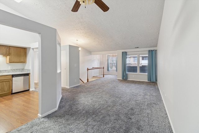 unfurnished living room with light carpet, a textured ceiling, and ceiling fan