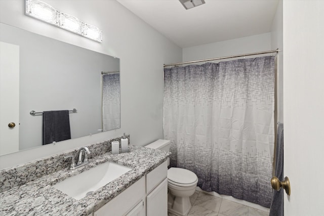 bathroom featuring curtained shower, vanity, and toilet