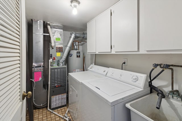 laundry room with cabinets, independent washer and dryer, sink, and water heater