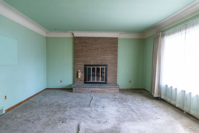 unfurnished living room with carpet flooring and a stone fireplace