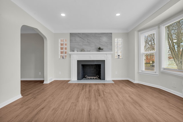 unfurnished living room with a fireplace and light hardwood / wood-style floors