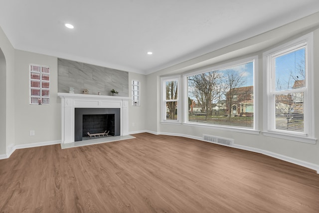 unfurnished living room with wood-type flooring and a fireplace