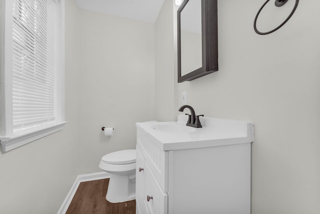 bathroom featuring hardwood / wood-style floors, vanity, and toilet