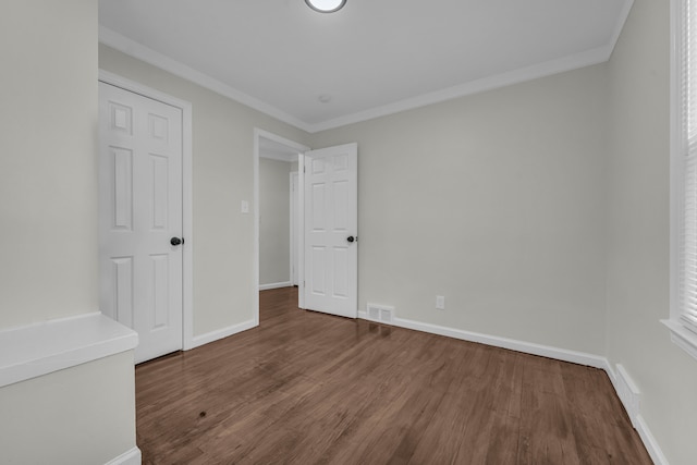 unfurnished bedroom featuring hardwood / wood-style flooring and ornamental molding