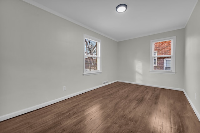 unfurnished room with hardwood / wood-style floors and crown molding