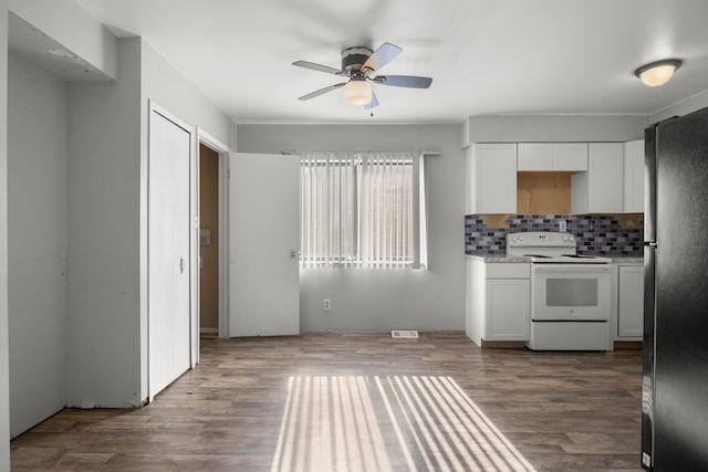 kitchen with decorative backsplash, refrigerator, ceiling fan, white electric range, and white cabinetry