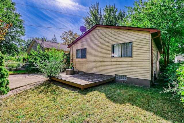 back of property featuring central AC unit, a yard, and a wooden deck