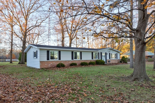 ranch-style house featuring a front yard and brick siding