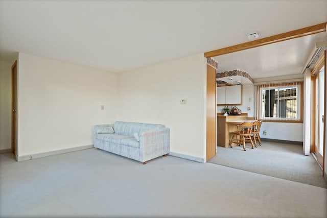 unfurnished room featuring carpet and baseboards