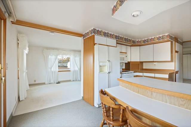 kitchen with light carpet, white appliances, white cabinetry, baseboards, and light countertops