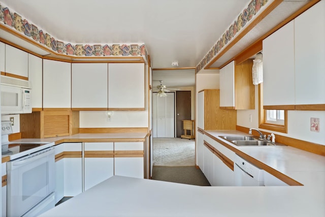 kitchen with light countertops, white appliances, and white cabinets