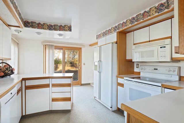 kitchen featuring white cabinets, white appliances, a peninsula, and light countertops