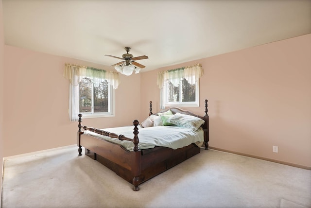 bedroom with ceiling fan, carpet, and baseboards