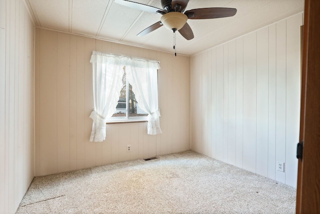 unfurnished room with a ceiling fan, light carpet, and visible vents