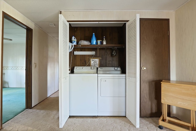 washroom featuring laundry area, separate washer and dryer, and light colored carpet