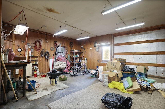 garage featuring a workshop area and wooden walls