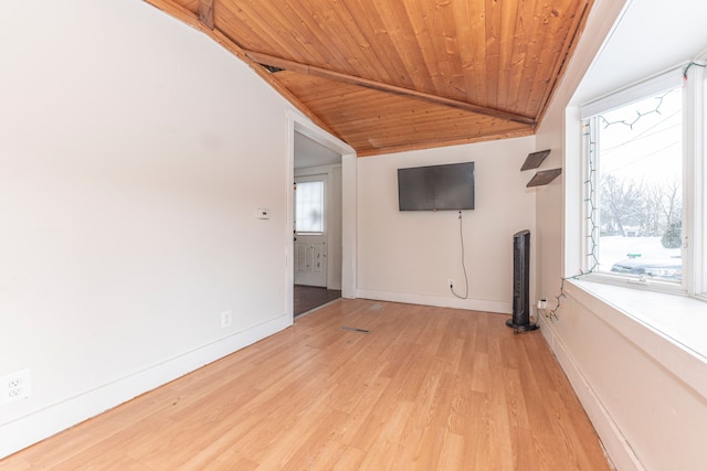 unfurnished living room featuring light hardwood / wood-style floors, vaulted ceiling, wood ceiling, and a healthy amount of sunlight