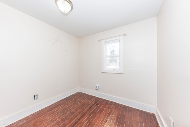 unfurnished room with dark wood-type flooring