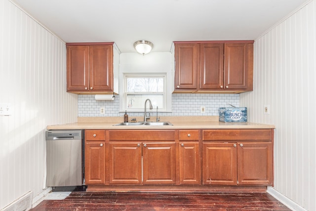 kitchen featuring sink, stainless steel dishwasher, dark hardwood / wood-style floors, and tasteful backsplash