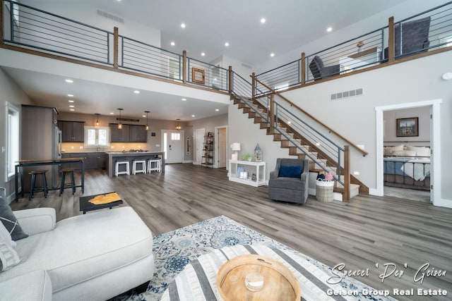 living room with dark hardwood / wood-style flooring and a high ceiling