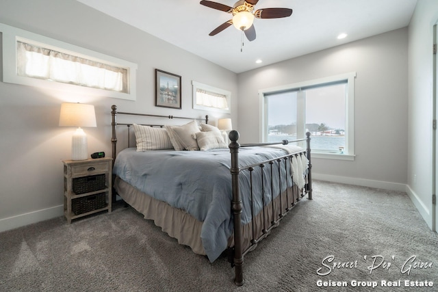 bedroom with dark colored carpet and ceiling fan