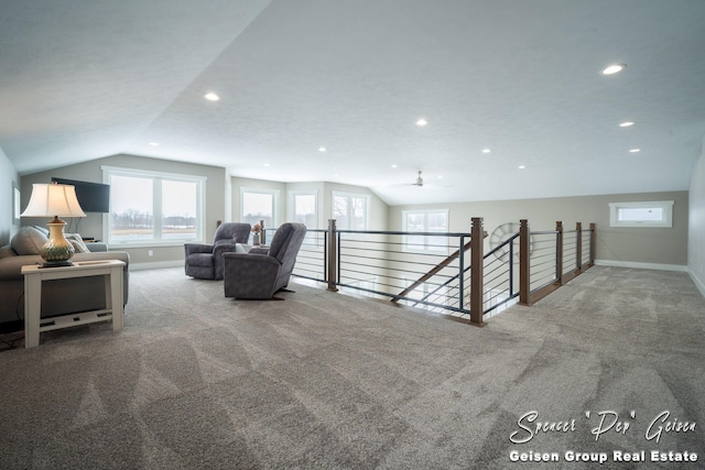 unfurnished room featuring ceiling fan, carpet, and vaulted ceiling