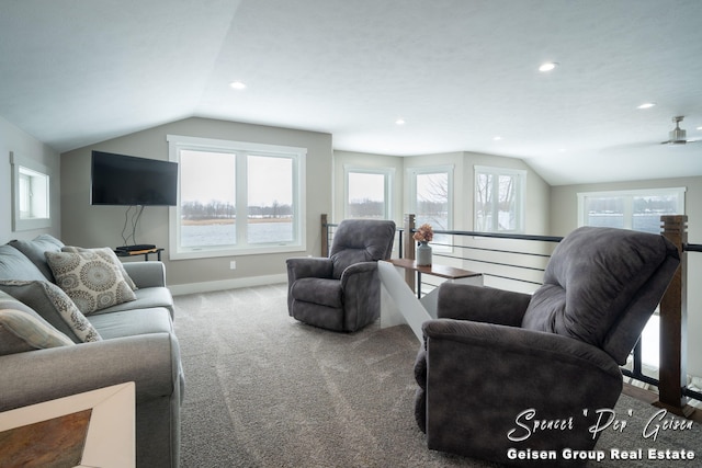 carpeted living room featuring ceiling fan, a healthy amount of sunlight, and vaulted ceiling