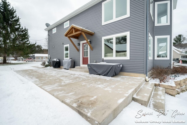 view of snow covered rear of property