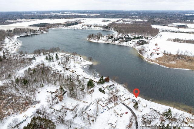 snowy aerial view featuring a water view