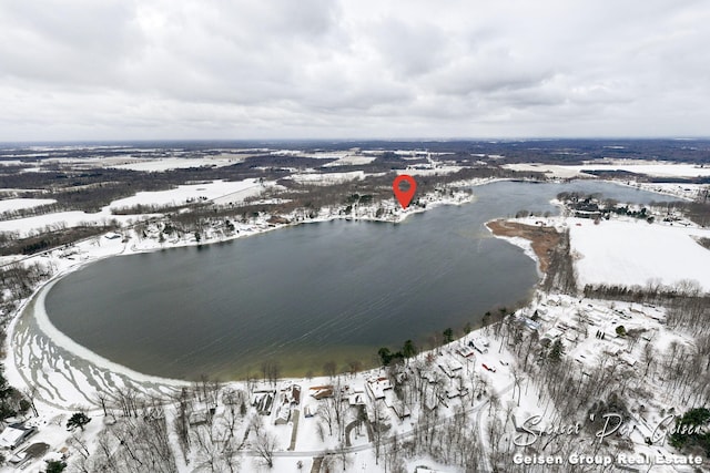 snowy aerial view featuring a water view