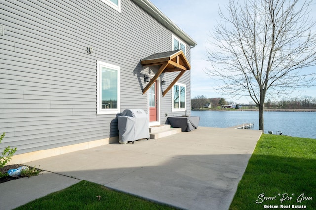 view of patio / terrace featuring a water view and a grill