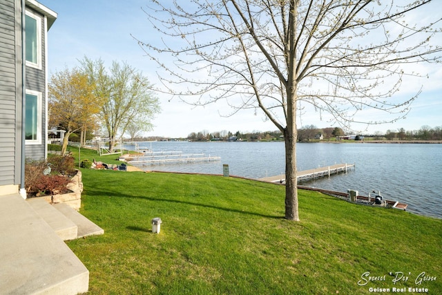 view of yard featuring a water view and a boat dock