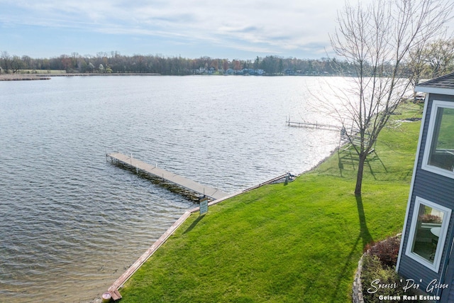 dock area with a lawn and a water view