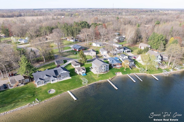 birds eye view of property with a water view, a residential view, and a forest view