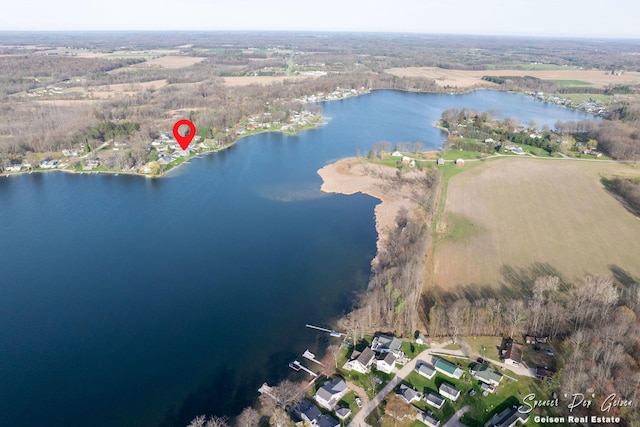 birds eye view of property featuring a view of trees and a water view