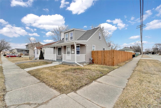 bungalow-style house with a porch and a front lawn