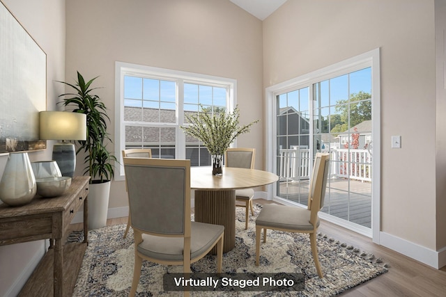 2519 Hunters Run Unit 101, Kalamazoo, MI 49048 - dining room with hardwood / wood-style floors and vaulted ceiling