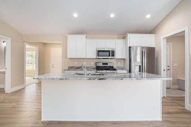 2519 Hunters Run Unit 101, Kalamazoo, MI 49048 - kitchen with white cabinets, sink, light stone countertops, an island with sink, and appliances with stainless steel finishes